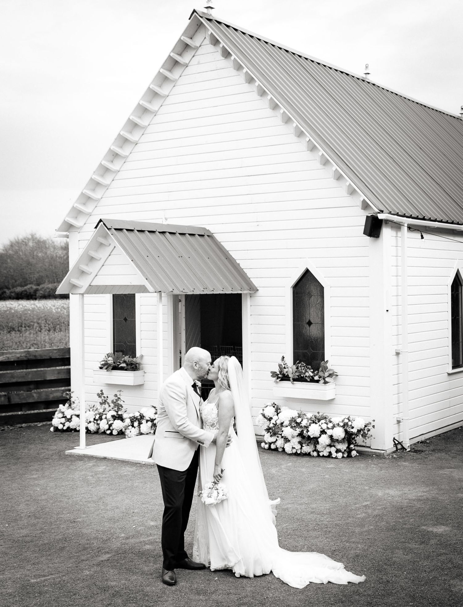 Wedding couple Kissing while out side the wedding chapel at Clanard court wedding venue