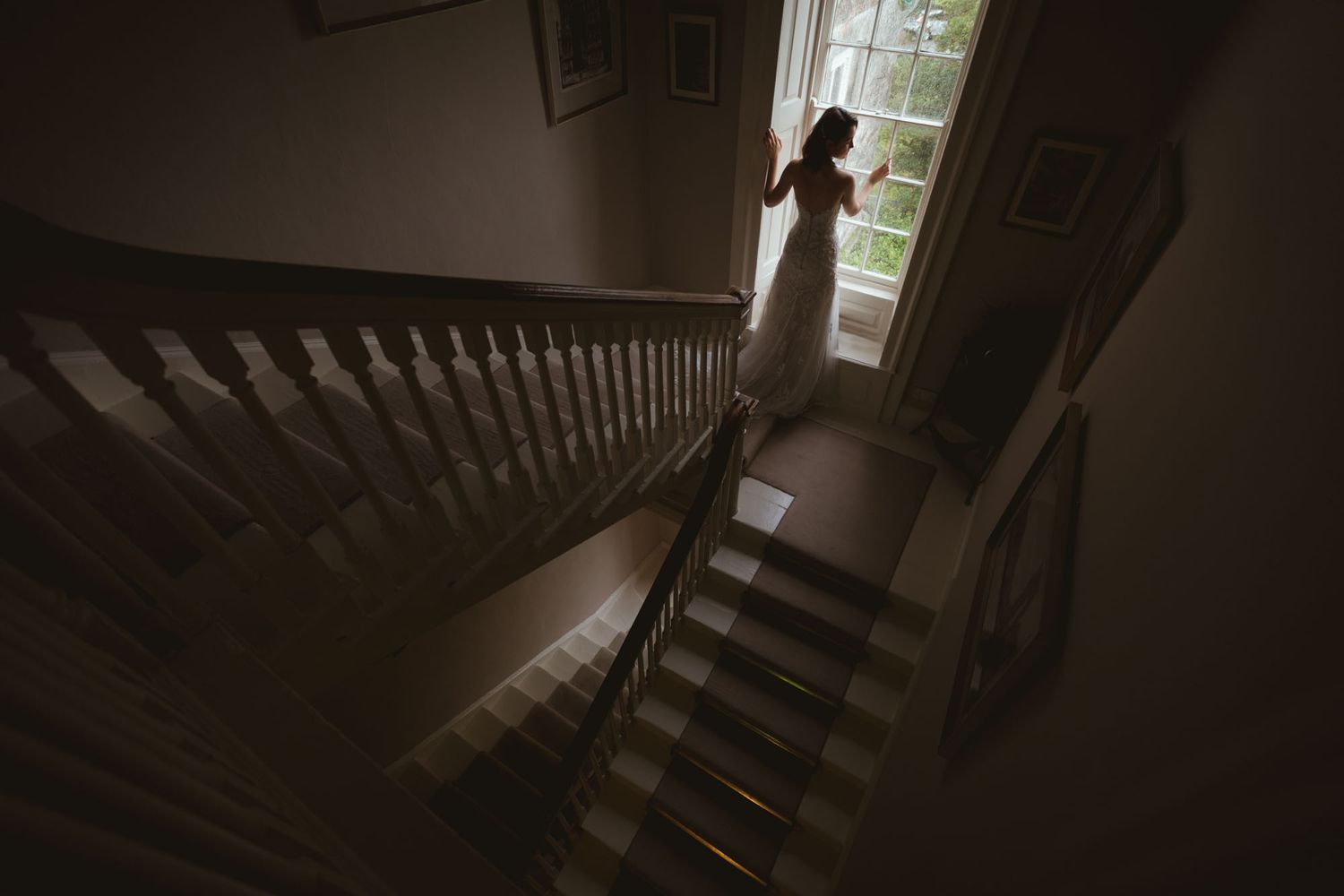 Bride standing at window at Kinsale wedding in Cork, photographed before the wedding by Paul Cowhig