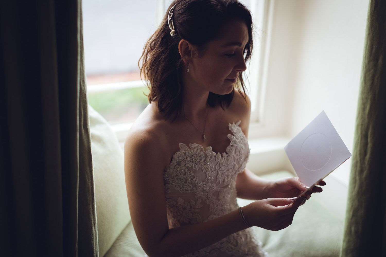 Candid moment of bride ready personal letter at  Ballymaloe House hotel in Cork.