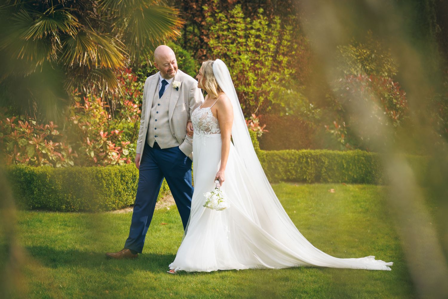 Couple walking hand in hand at Clanard grounds during their wedding in Kildare