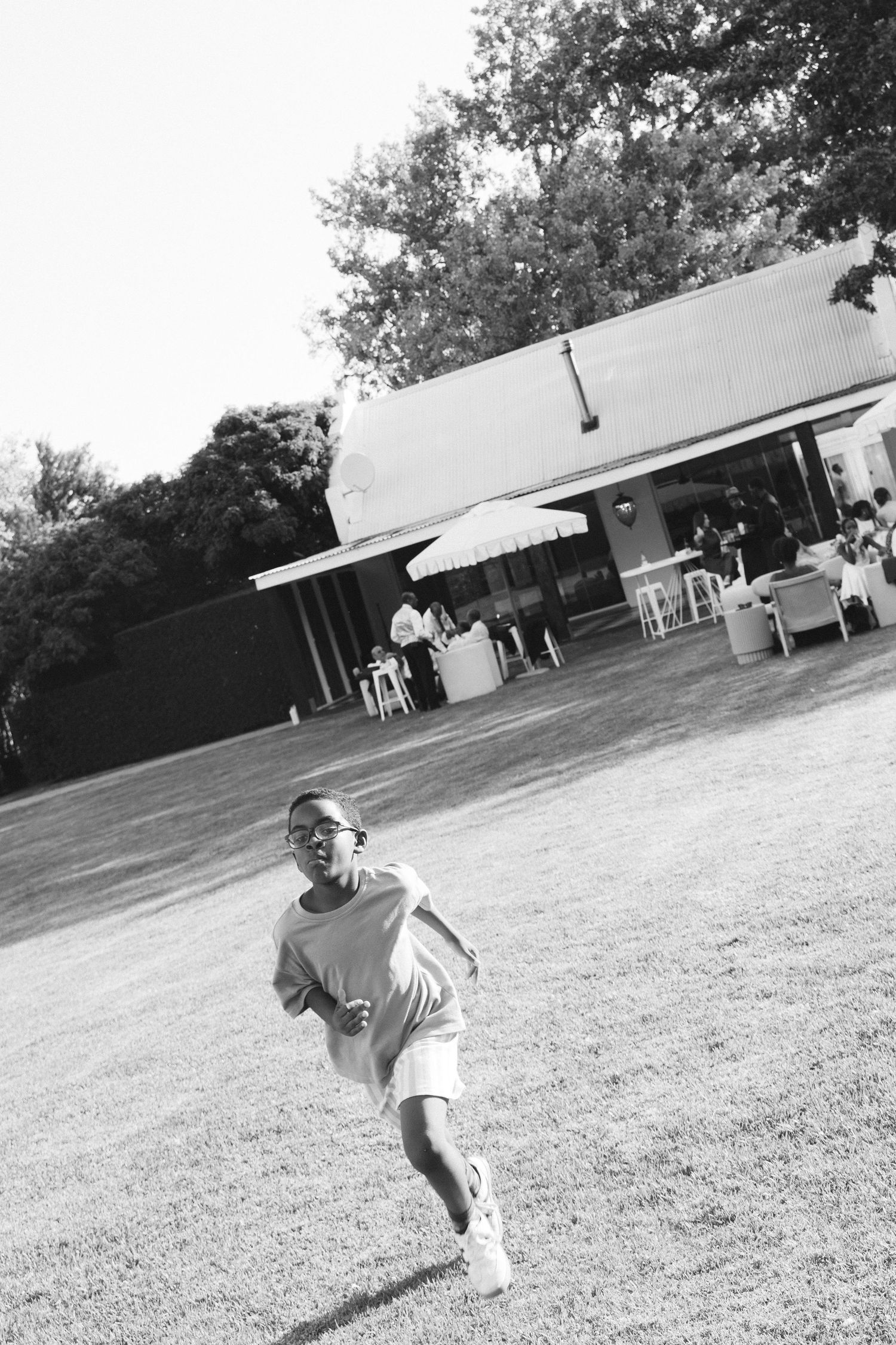 Black and white sequence of a baseball pitcher going through their windup motion on a grassy field.