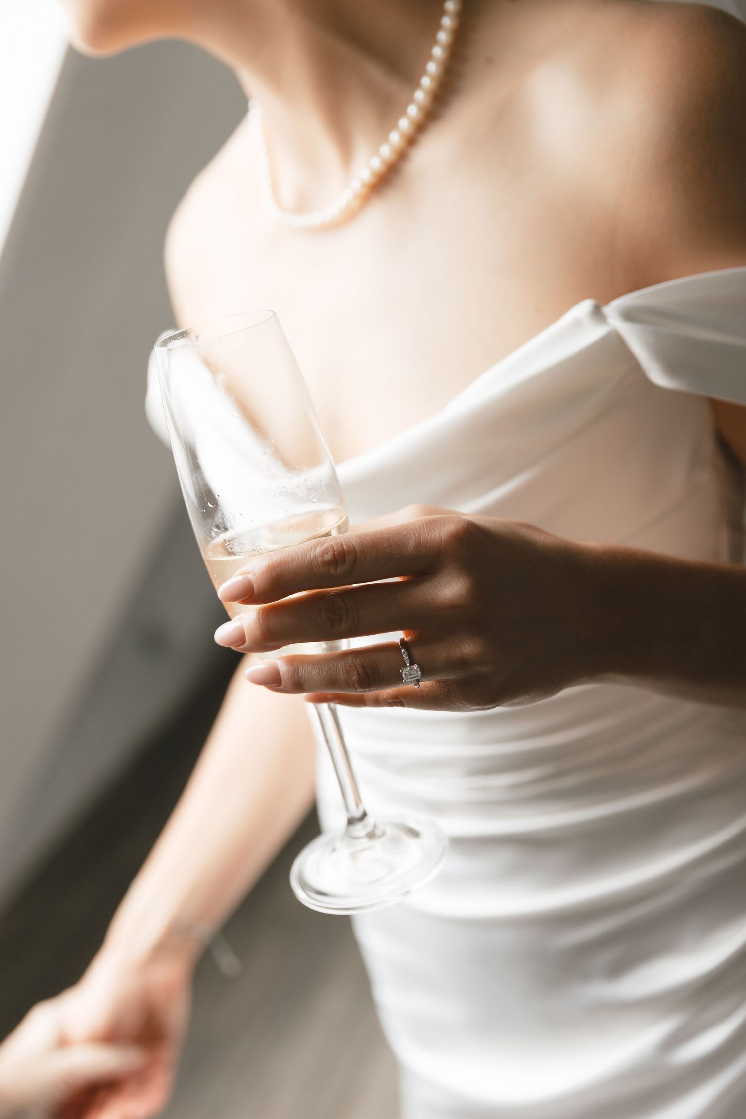 A series of cropped detail shots showing a white wedding dress with pearl necklace in soft natural lighting.
