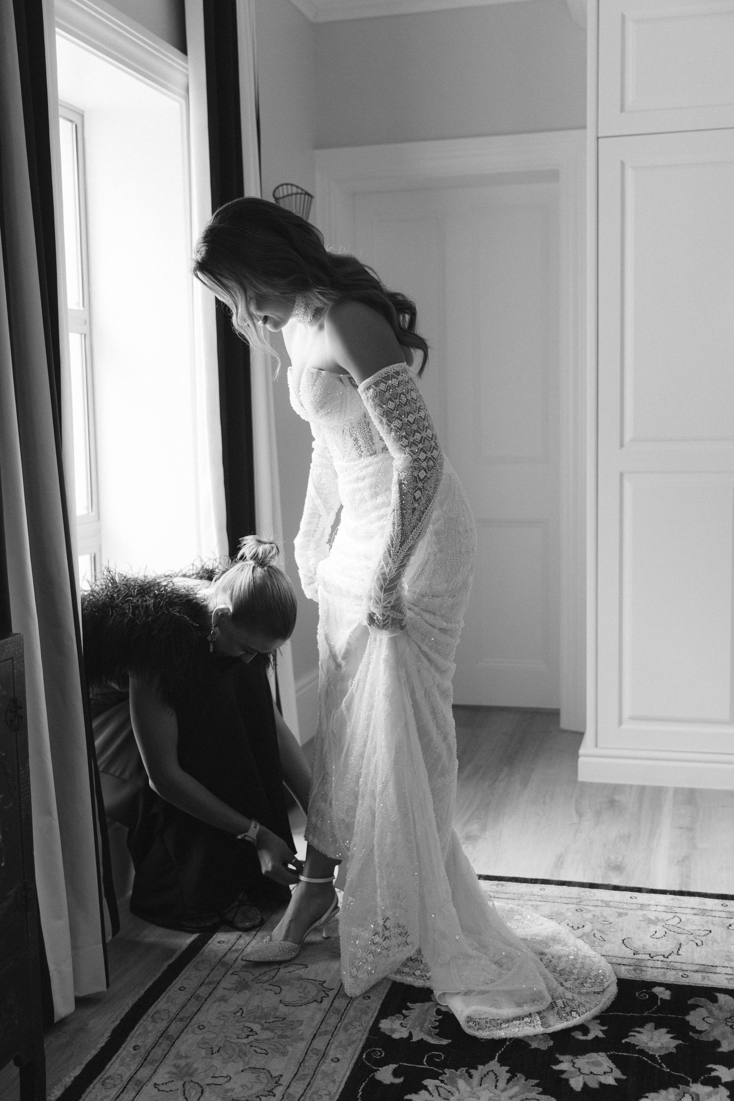 A series of black and white photos showing someone in a flowing white dress moving gracefully in a bright room.