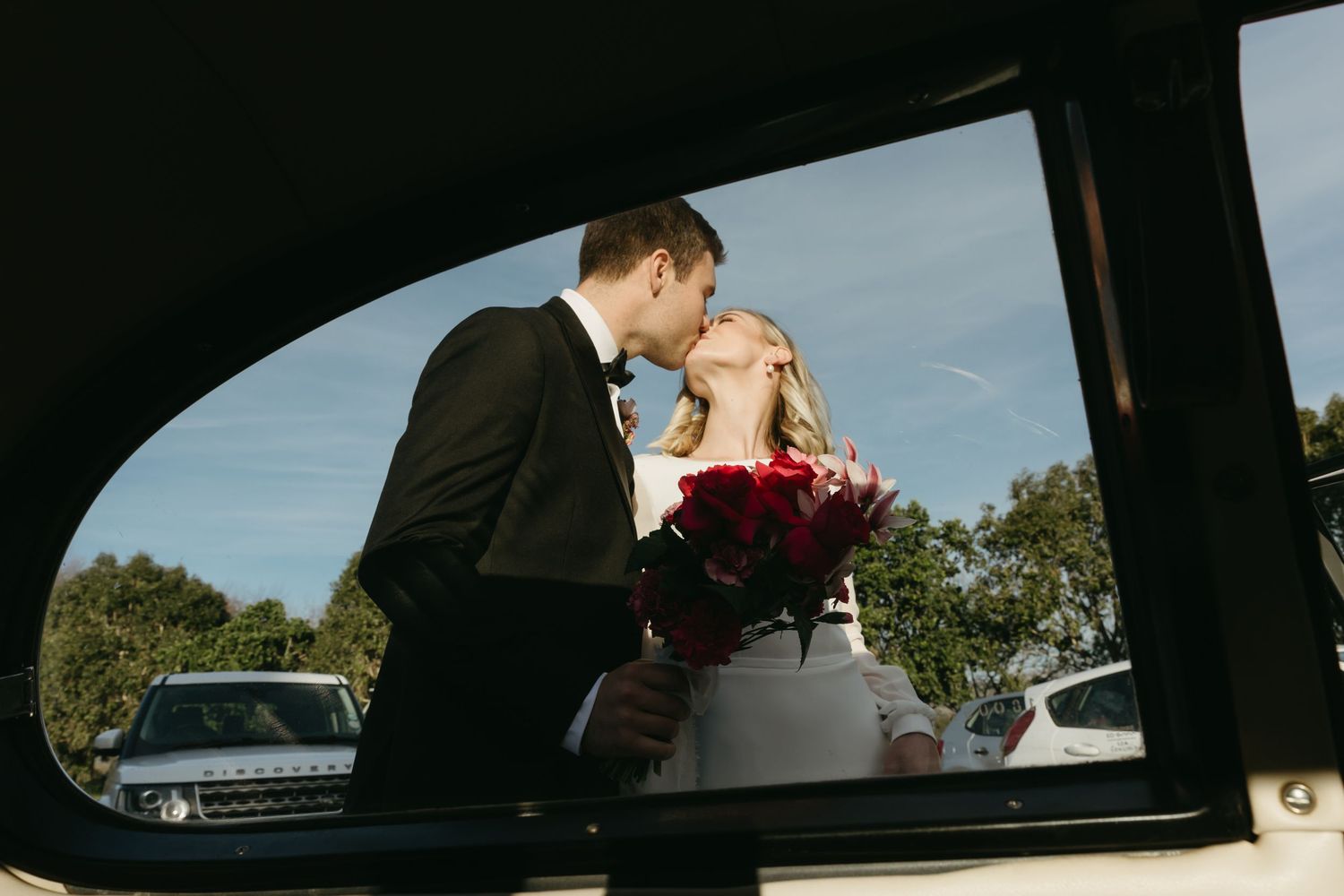 A series of romantic wedding photos taken through car windows showing intimate moments between a couple.