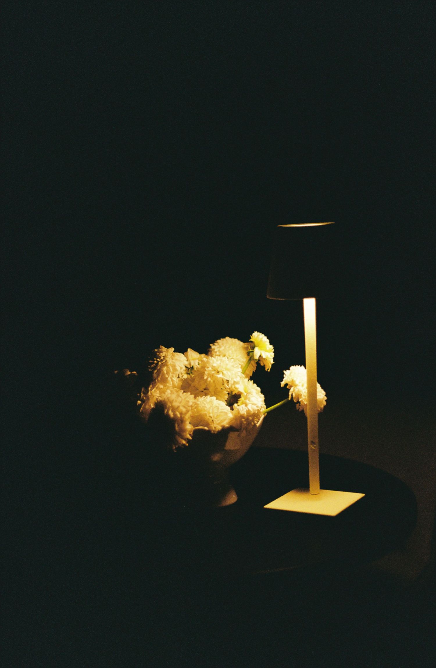 Dark artistic photograph of illuminated candles creating dramatic shadows and light patterns.