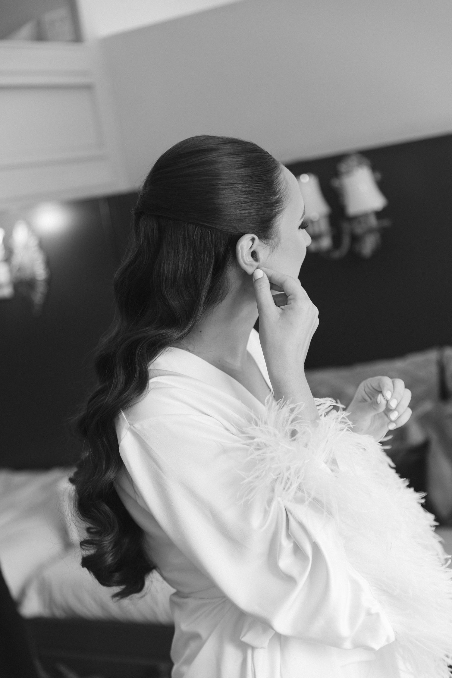 Person in white robe getting ready in black and white photography.