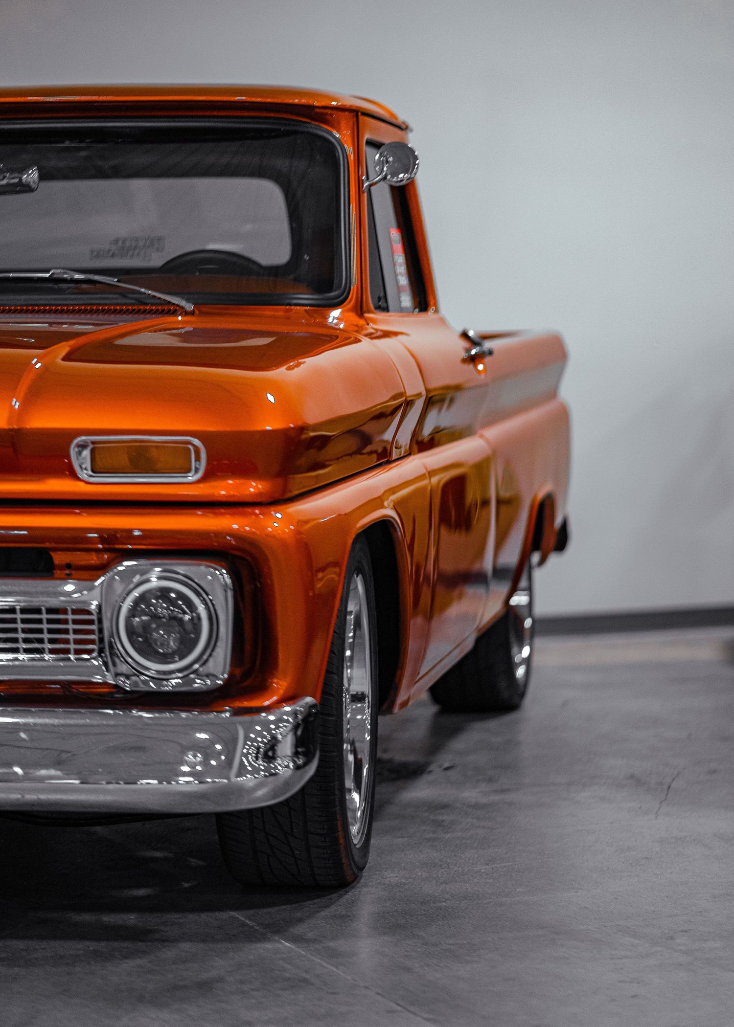 Classic orange GMC pickup truck photographed from multiple angles on gray background.