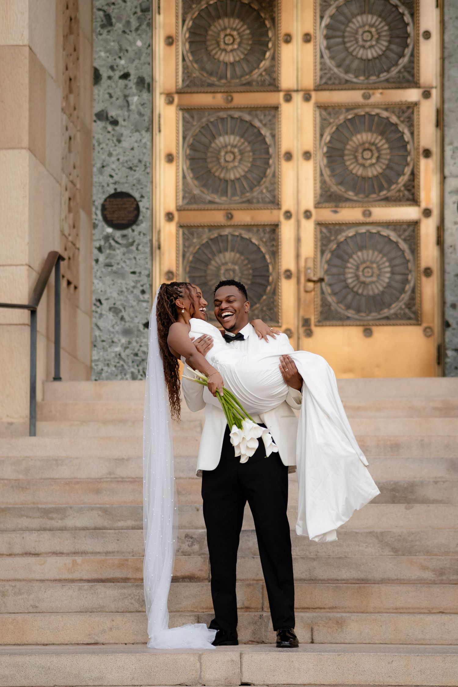 Black bride and groom walking together after their wedding ceremony