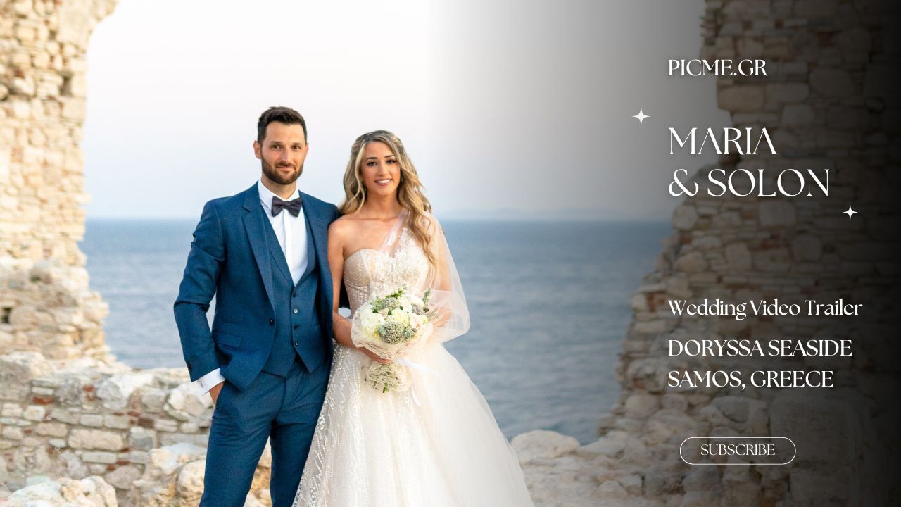 An elegant bride and groom pose together by the ocean in formal wedding attire against a coastal backdrop.