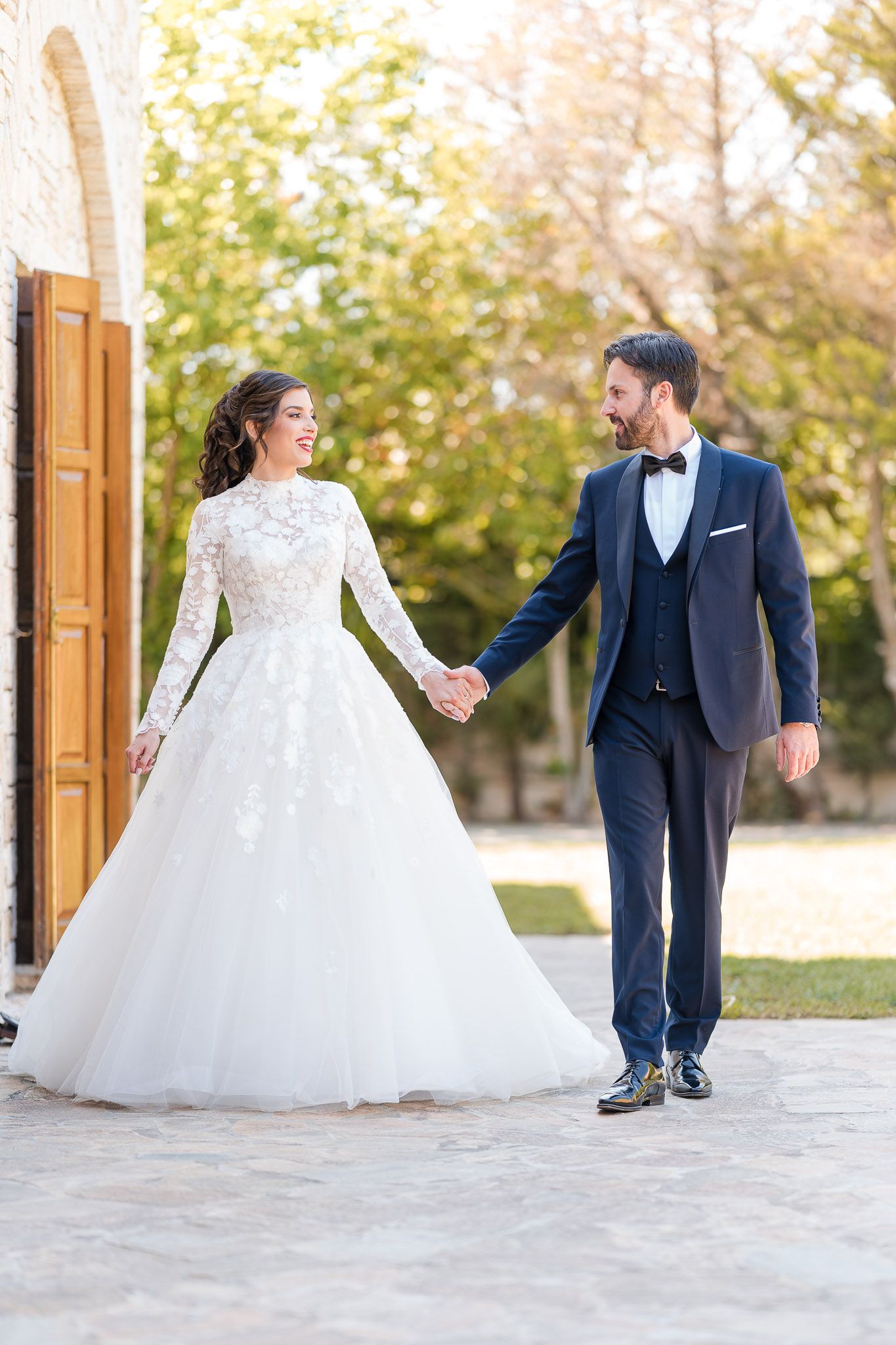 A sequence of romantic wedding photos shows a couple dancing and twirling in elegant formal attire outdoors.
