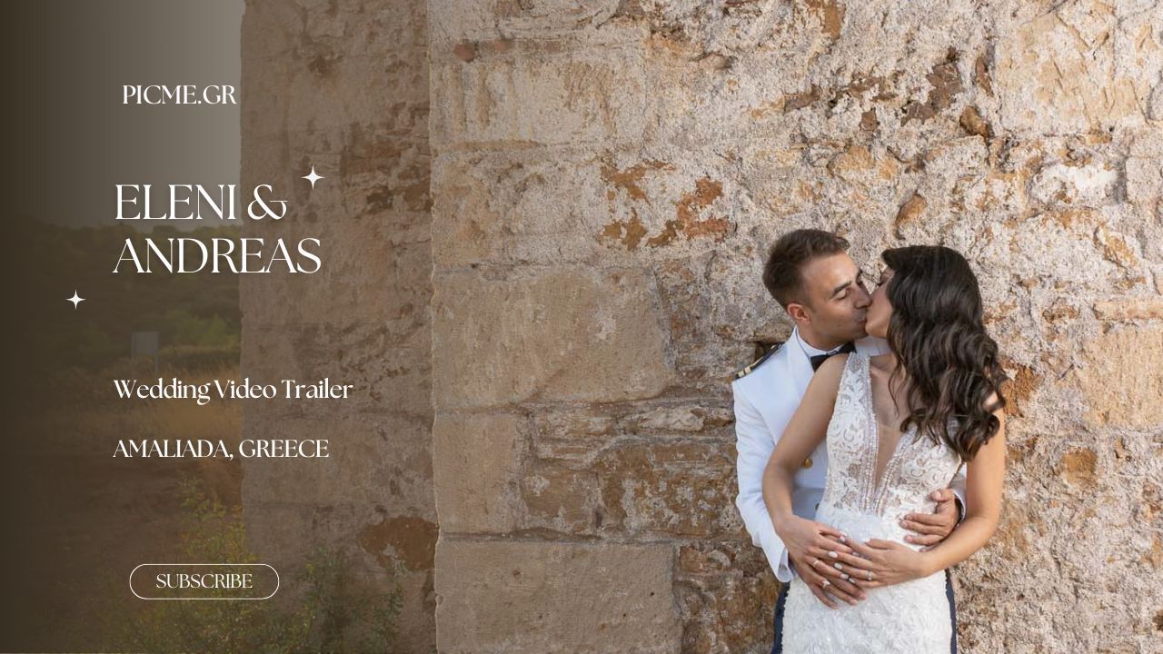 Romantic couple stands against a rustic stone wall with a vintage wedding sign above.