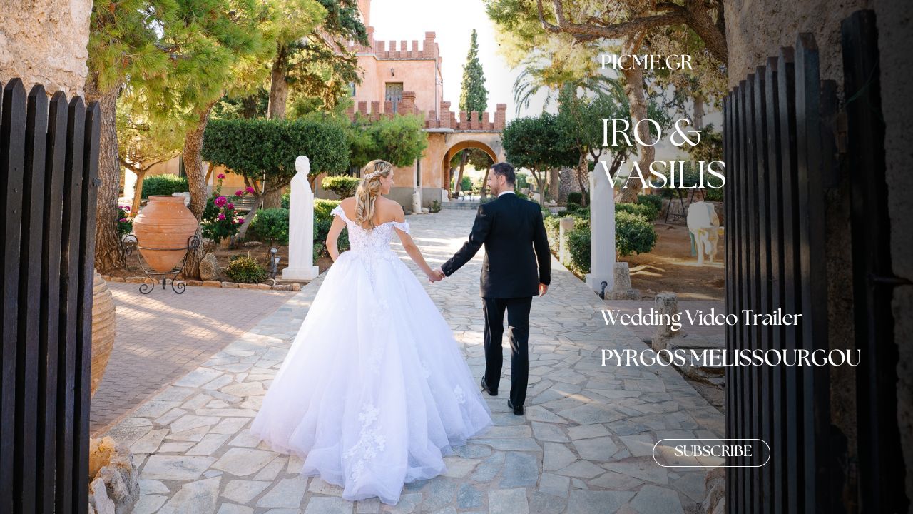 A wedding couple walks down a historic cobblestone street with elegant stone architecture and trees.