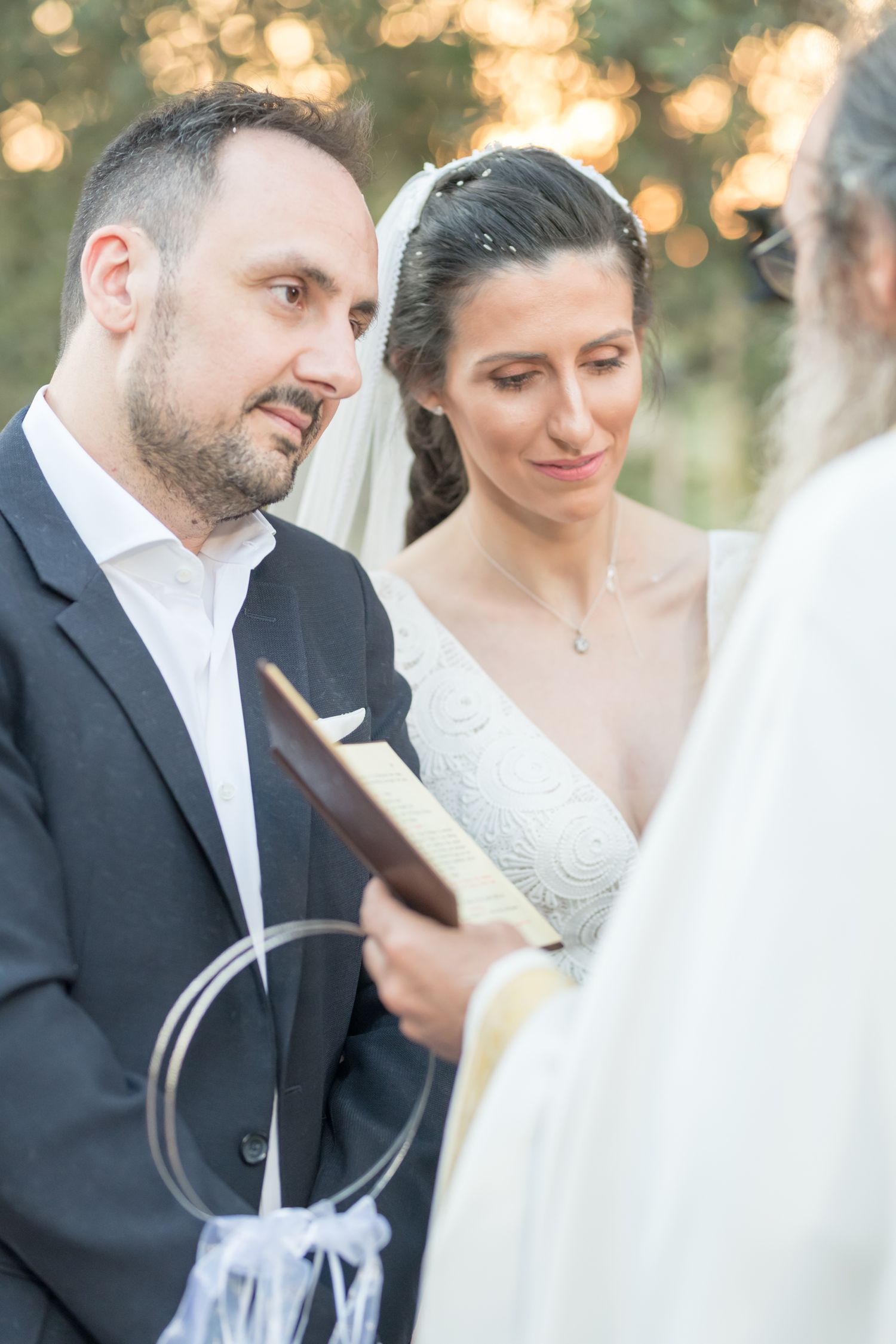 A series of romantic wedding photographs showing candid moments between a bride and groom with bokeh lighting in background.