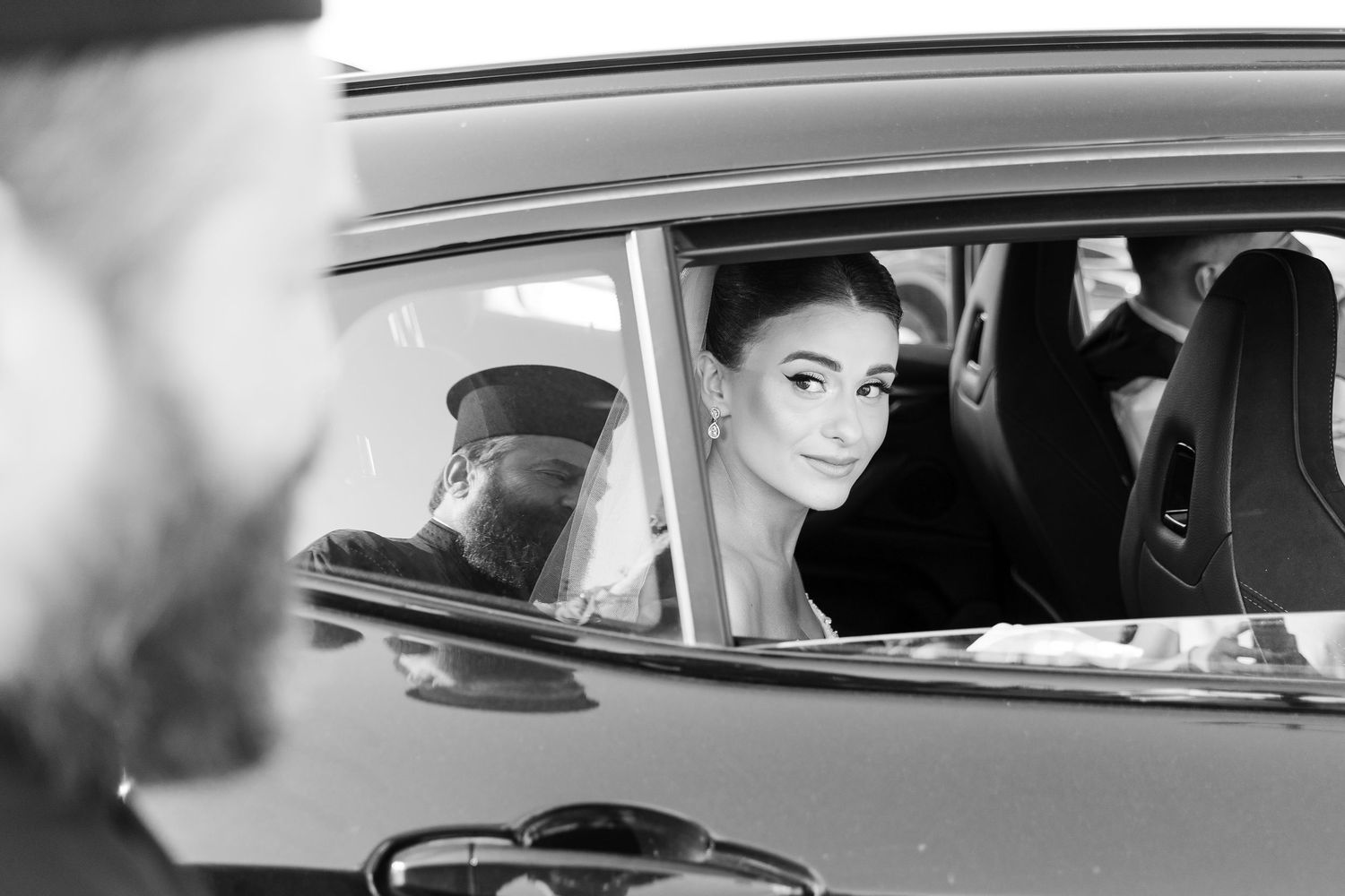 Classic black and white photograph showing a vintage car interior.