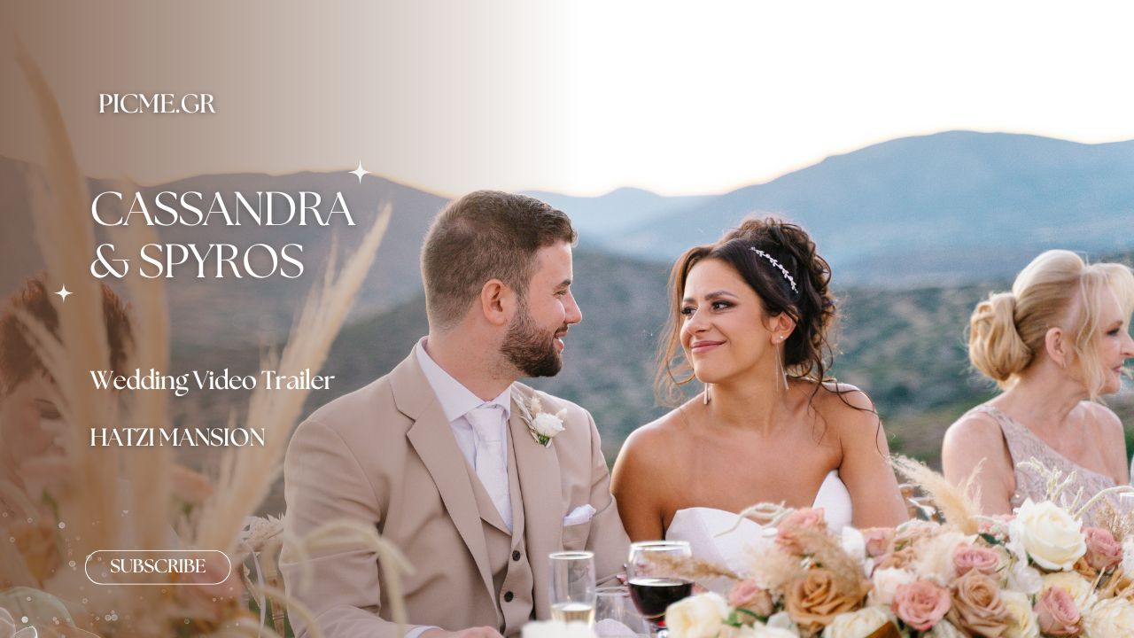 A happy couple laughs while sitting outdoors at an elegant table setting with pink floral arrangements and mountains.