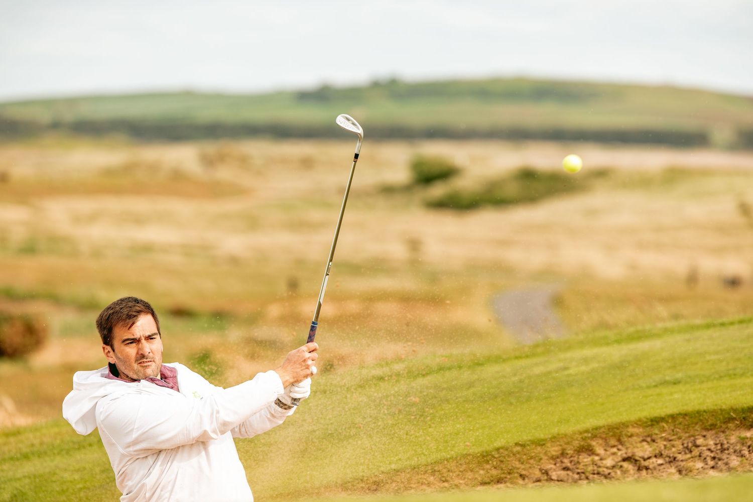 Golfer played a big shot at Dumbarnie Links, in complete action.