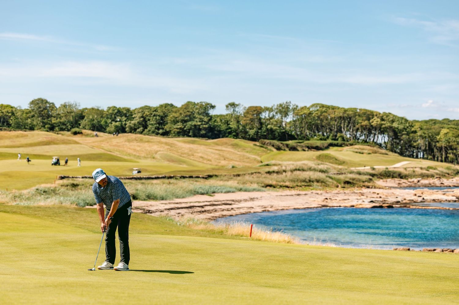 Man in shaft lean position ready to play shot, playing at Kingsbarns Links.