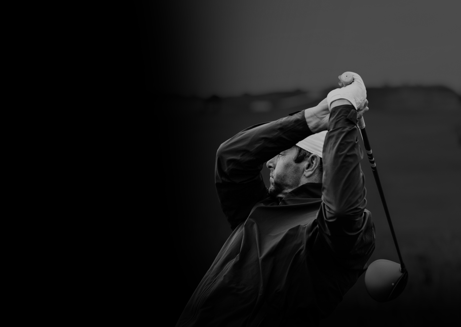 Golfer in action with golf club rotated after shot