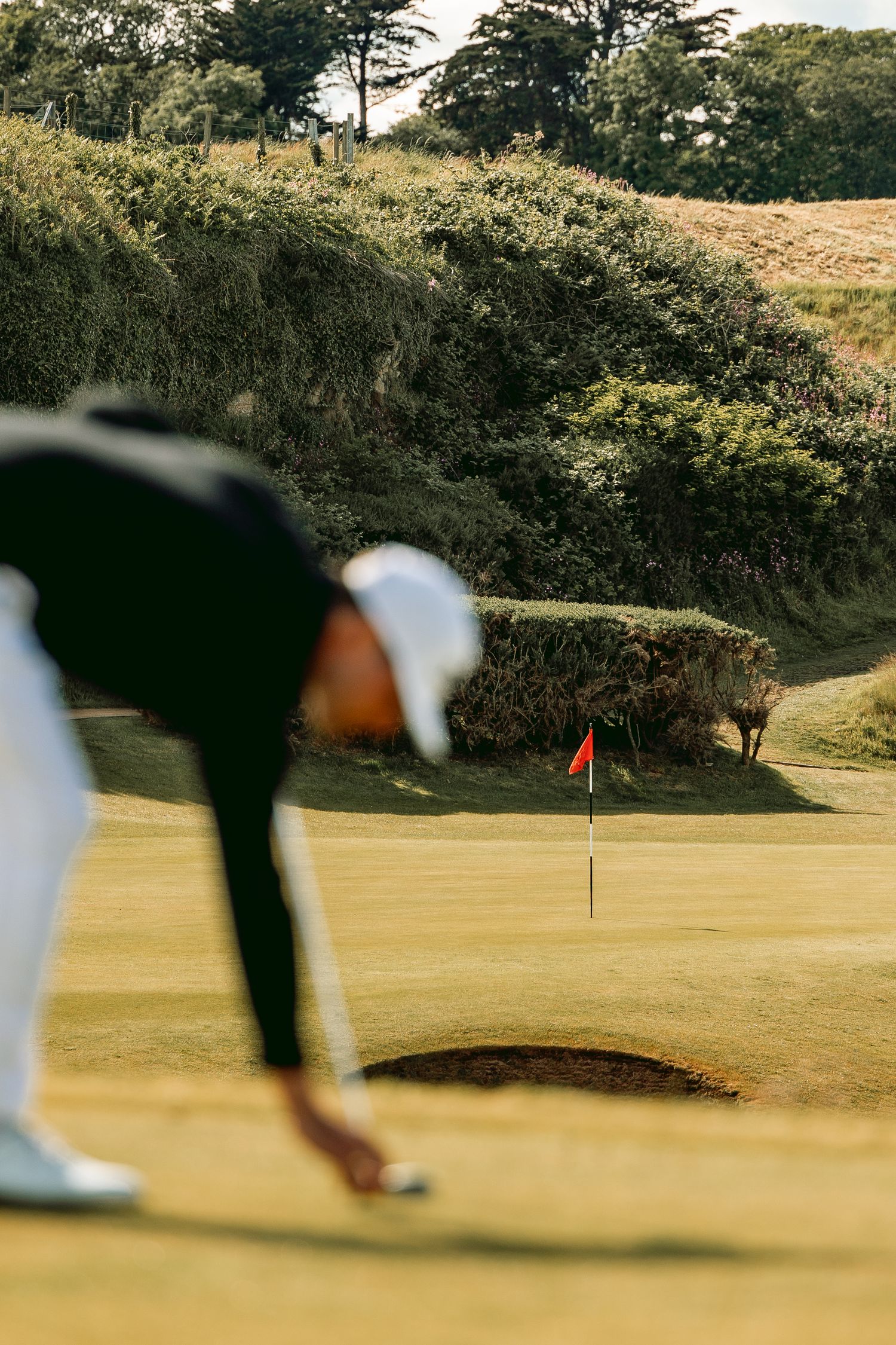 Golfer doing ball placement before shot