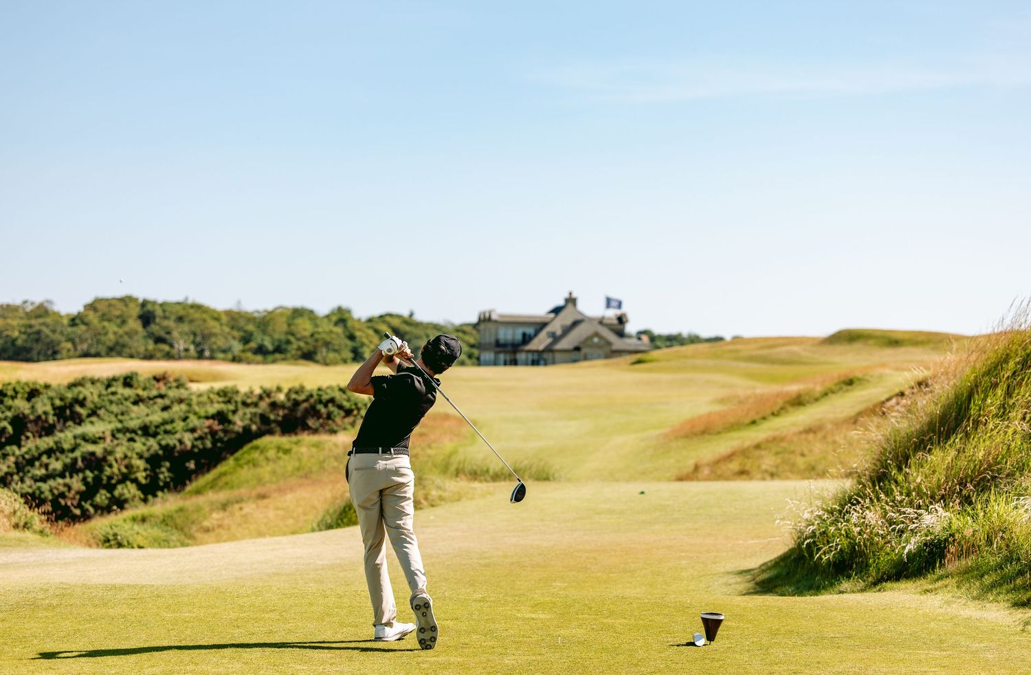 A golfer in action after playing a big shot at Kingsbarns Links.