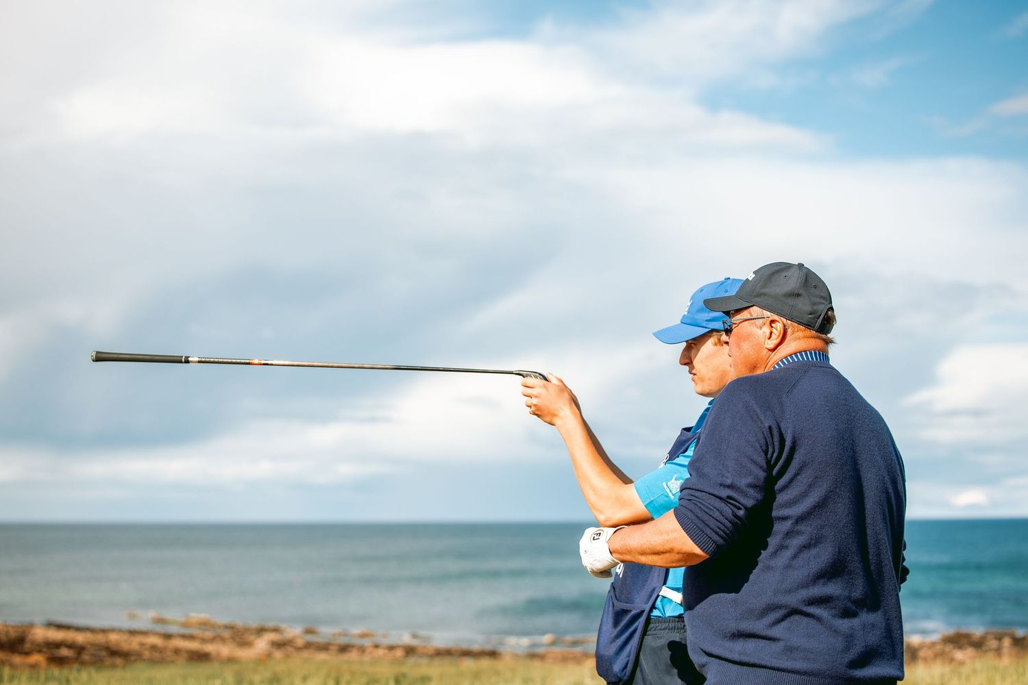 Golf guide pointing far showing direction to a golf player