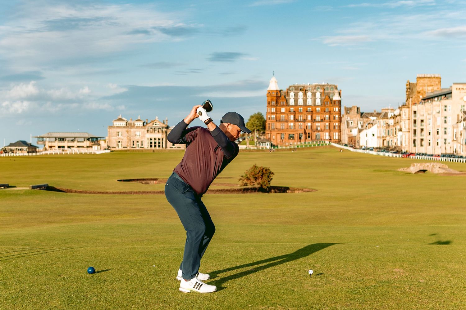 A golder playing at Old Course, St Andrews, ready to hit the golf ball.