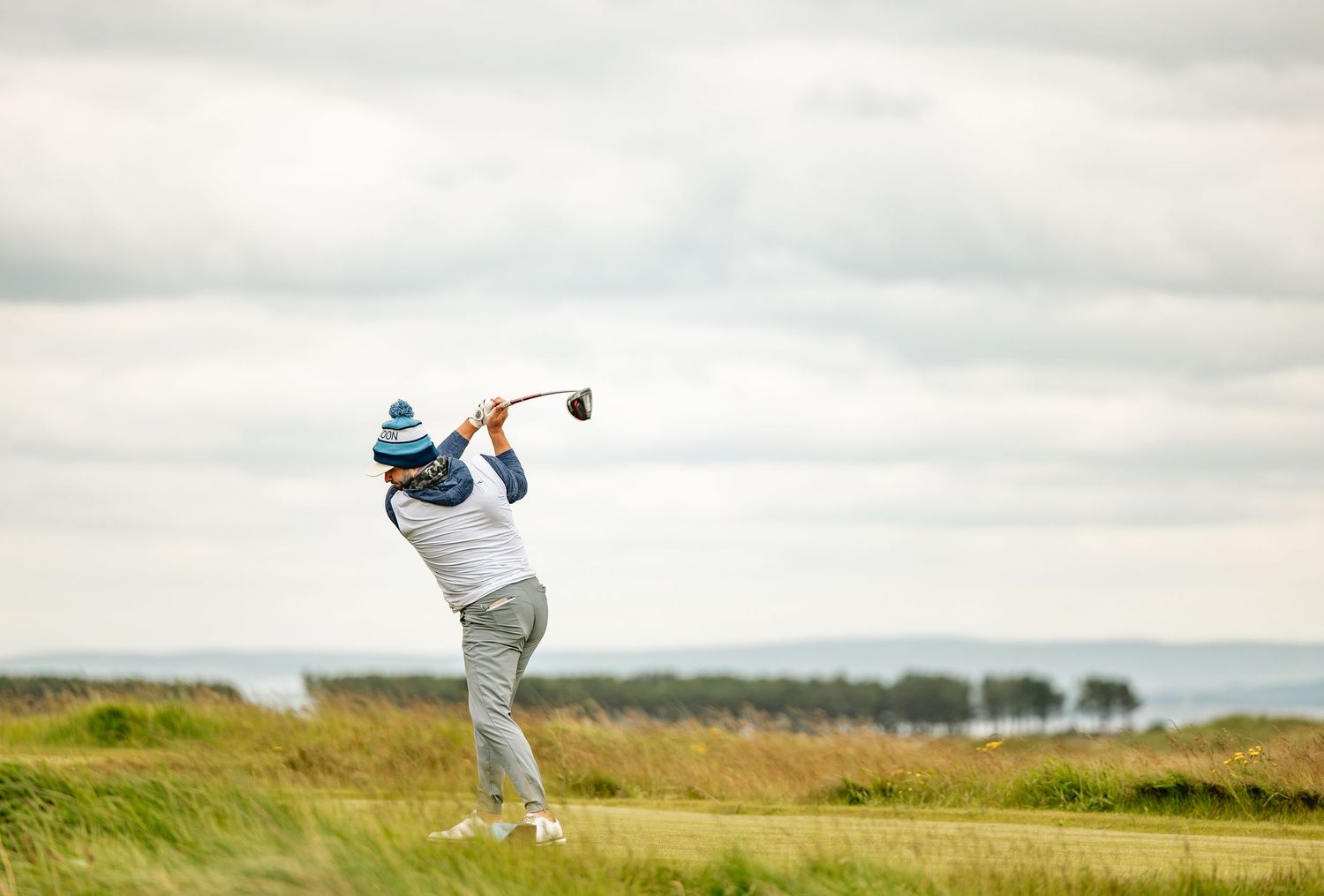 A golfer in action after playing a shot at Dumbarnie Links.