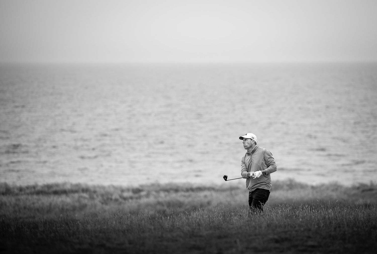 Golfer in action, playing at Kingsbarns Links