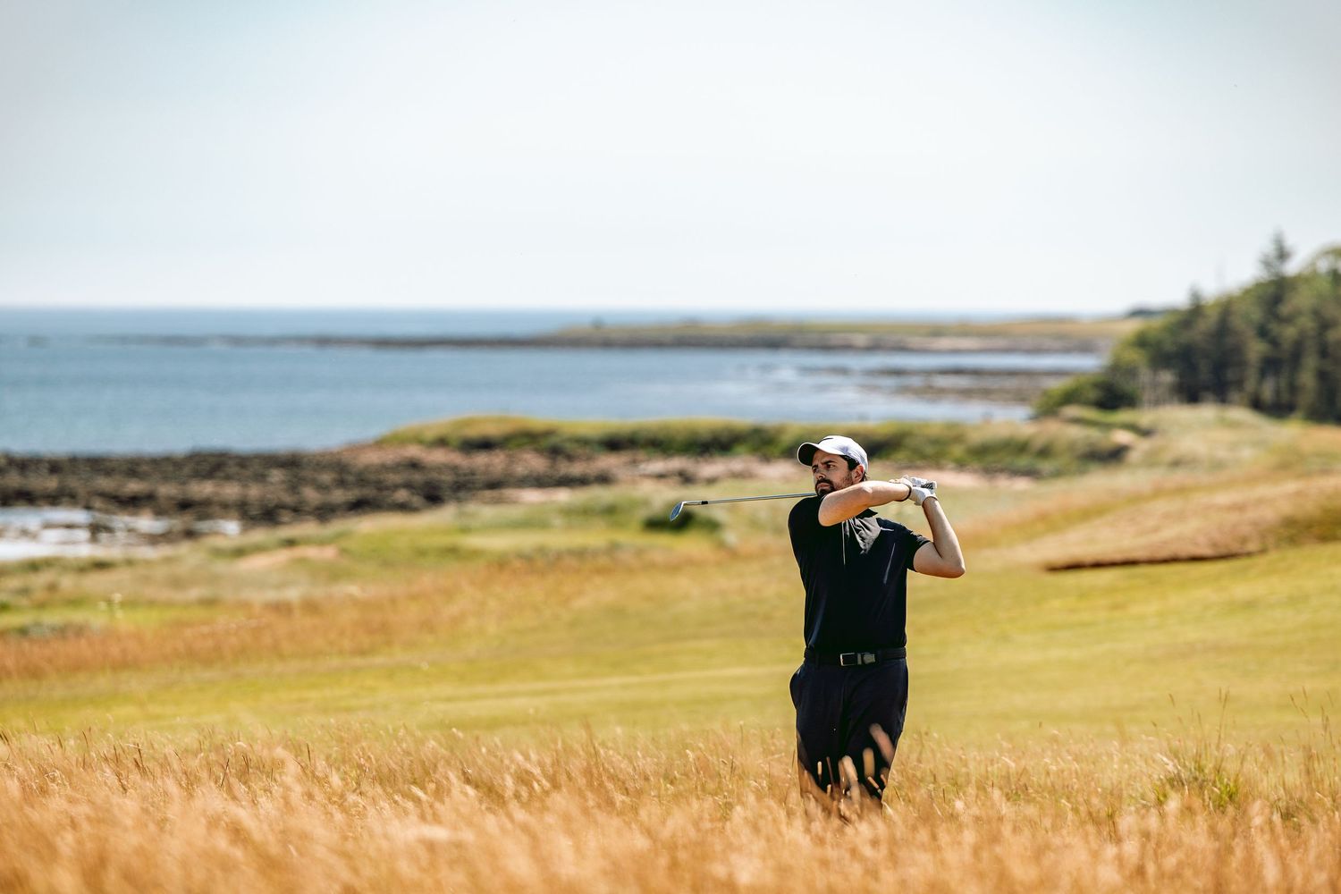 A golfer at Kingsbarns Links played shot in action.