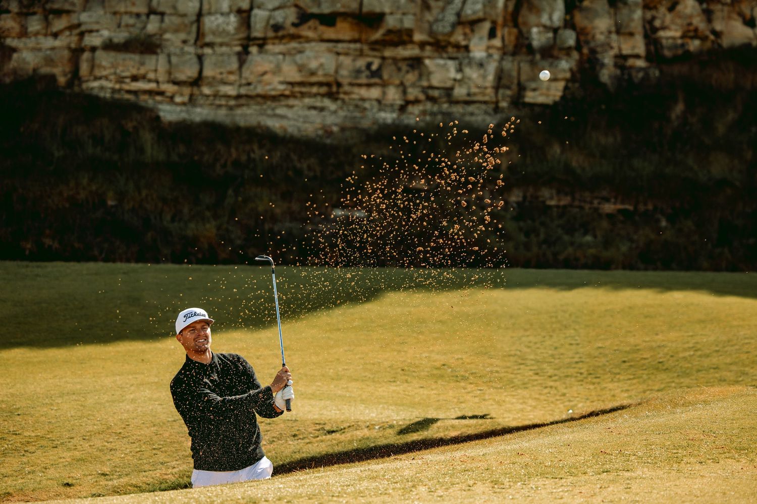 Golfer at kingsbarns links in action, after playing a shot