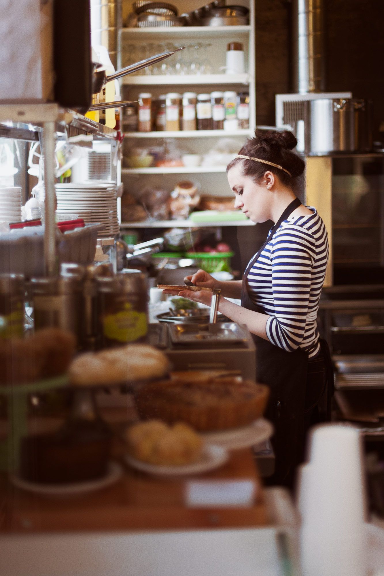 Barista making a sandwich at a local cafe in Portland, Oregon.
