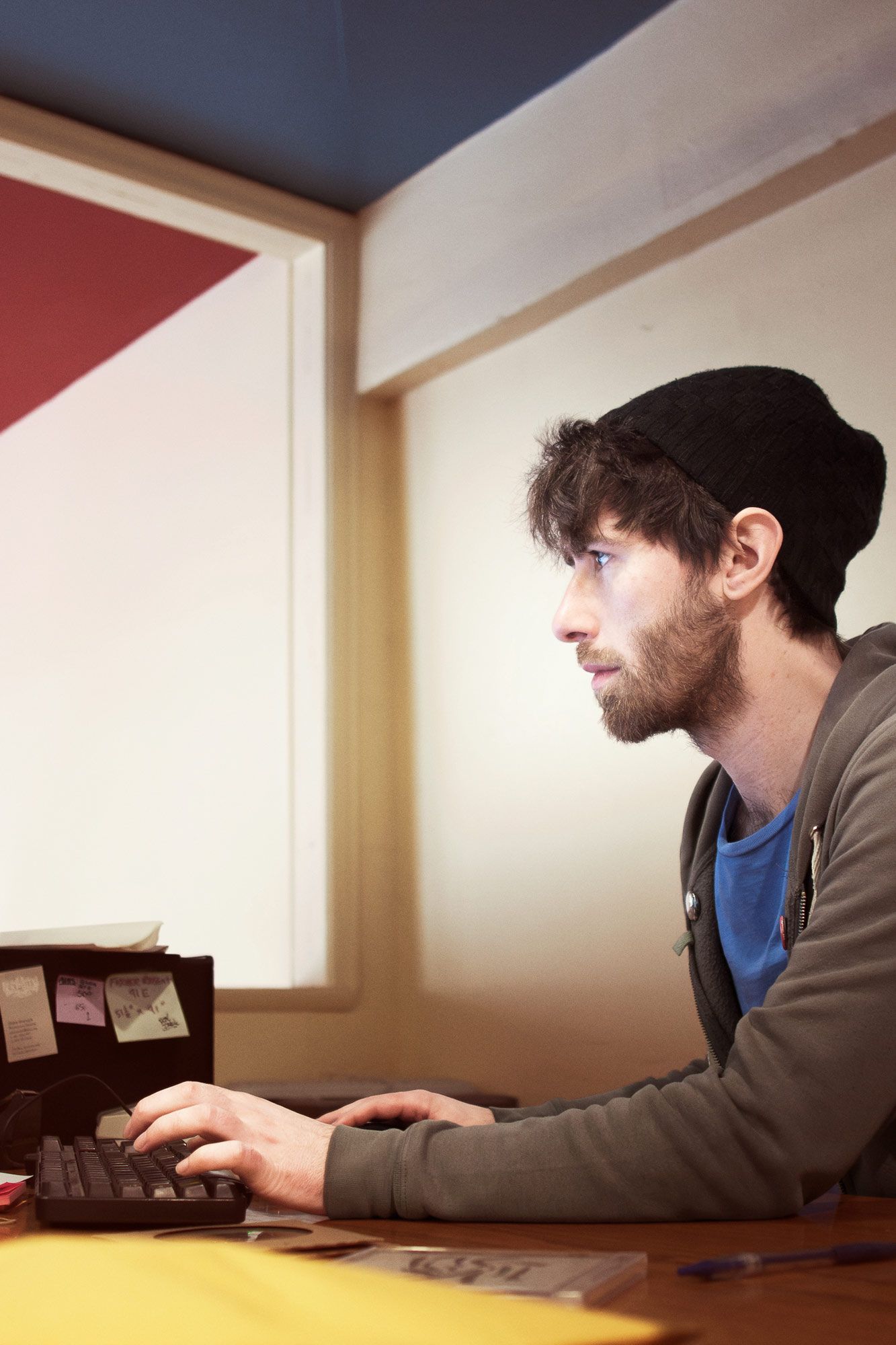 Record shop employee responding to messages while sitting at the computer and typing on the keyboard.