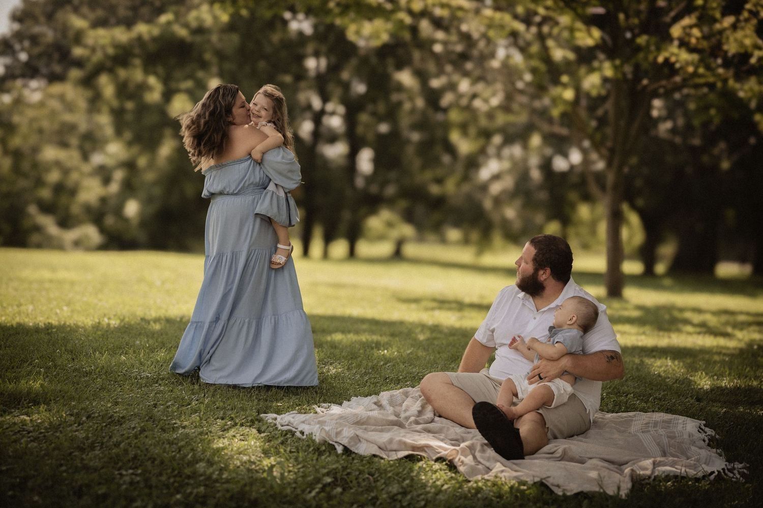 Couple lying on a blanket in a sun-drenched park during an autumn afternoon.