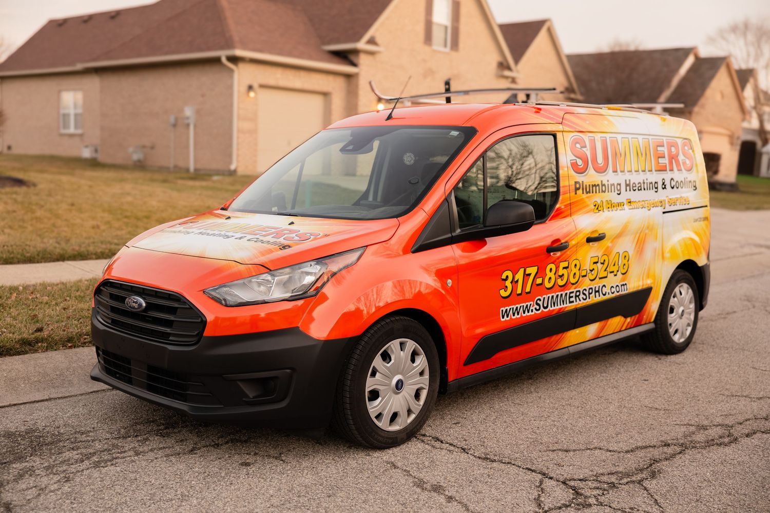Summers Plumbing Heating and Cooling branded orange service van parked in a residential neighborhood.