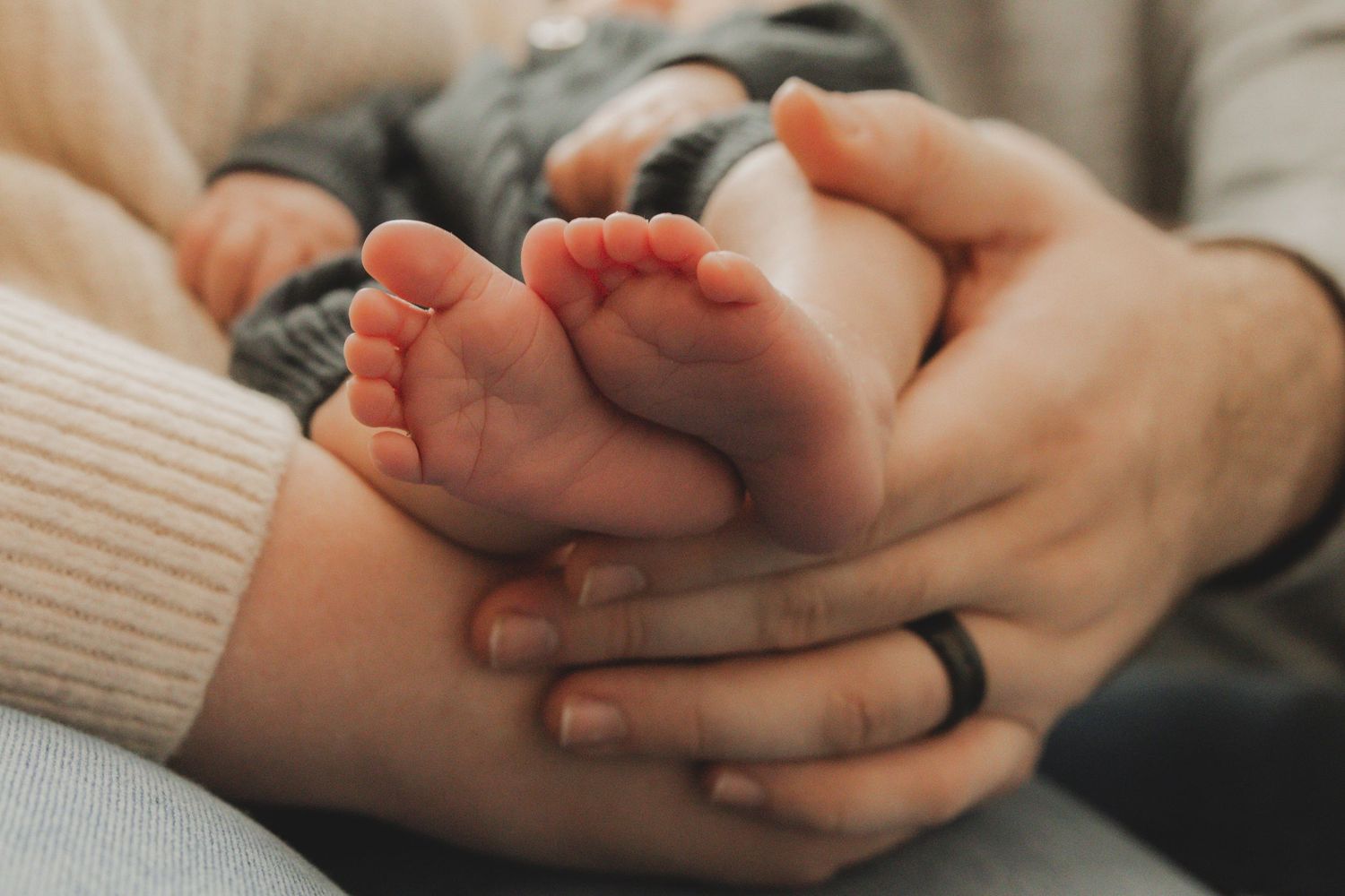 Close up of gentle hands holding together in an intimate gesture.