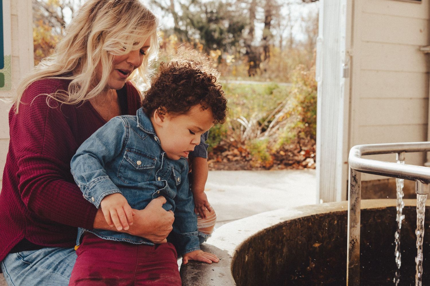 Heartwarming family moment captured in natural light outdoors during fall season.