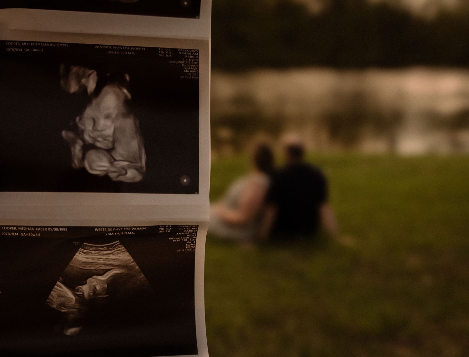 Intimate maternity photoshoot outdoors with couple sitting together in warm evening light.