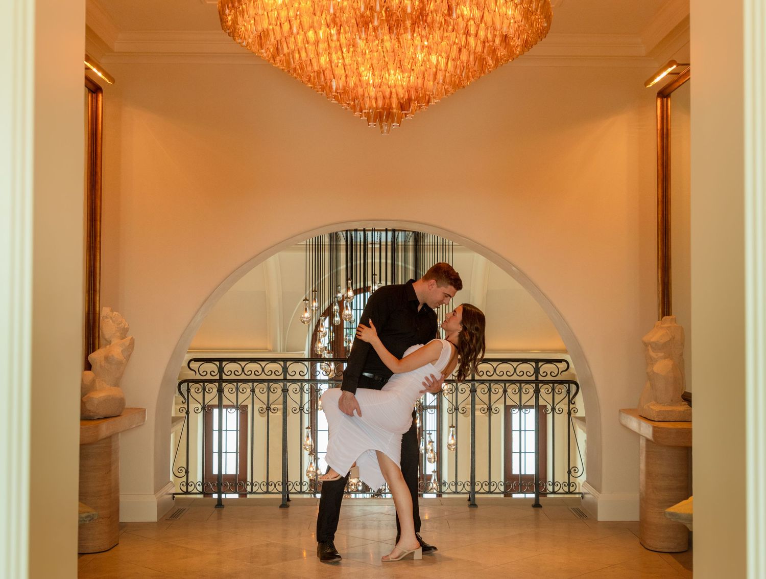 Elegant ballroom photoshoot sequence under warm lighting and ornate chandeliers.