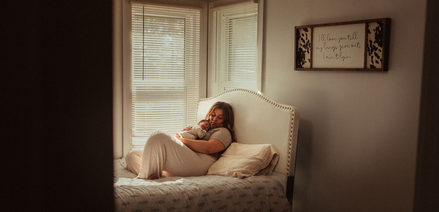 Soft window light illuminates peaceful bedroom scene with white bedding.