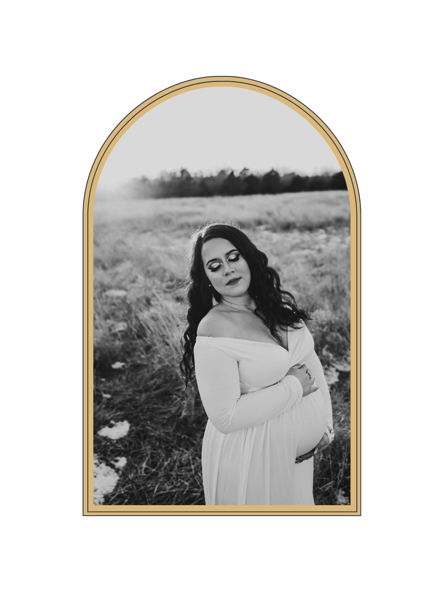 Black and white portrait of pregnant woman in white off-shoulder dress in a field, gold arch frame.