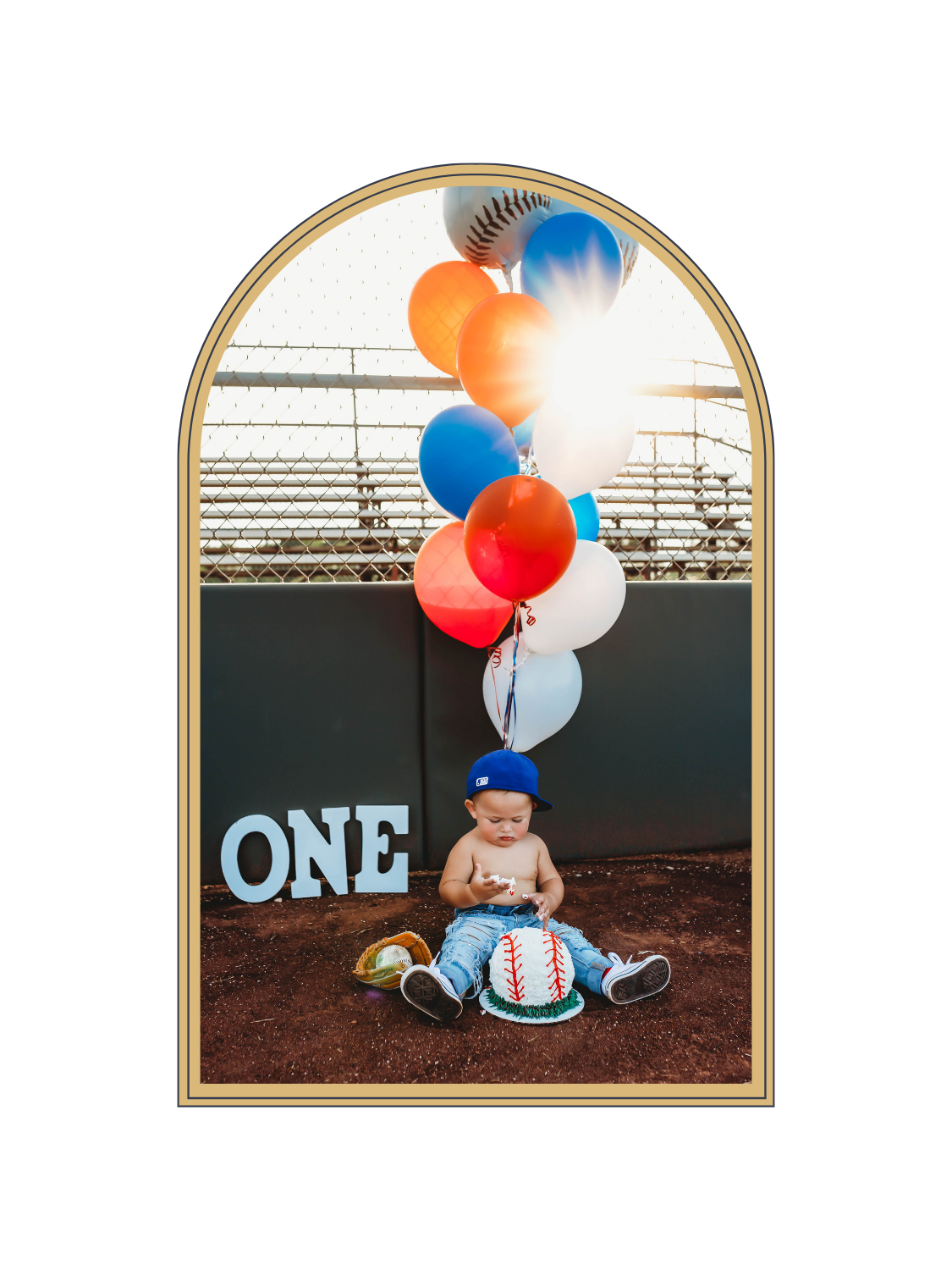 Baby boy's first birthday baseball themed photo shoot with colorful balloons and ONE sign at a baseball field.