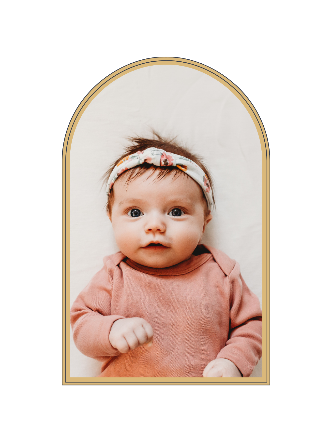 Adorable newborn baby girl wearing a floral headband and pink onesie, photographed in an elegant gold arch frame.