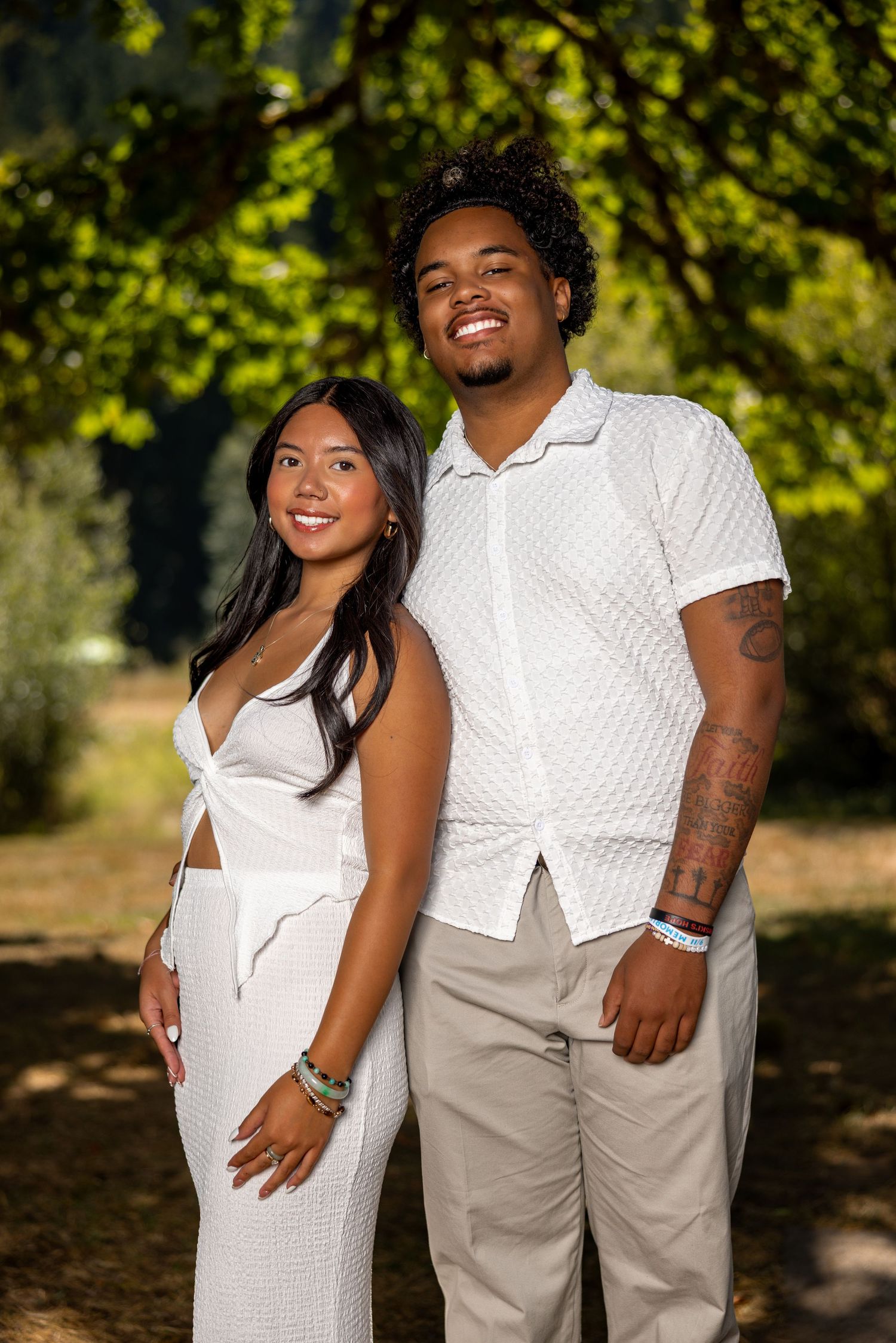 Outdoor couple photos with white and khaki coordinated outfits.