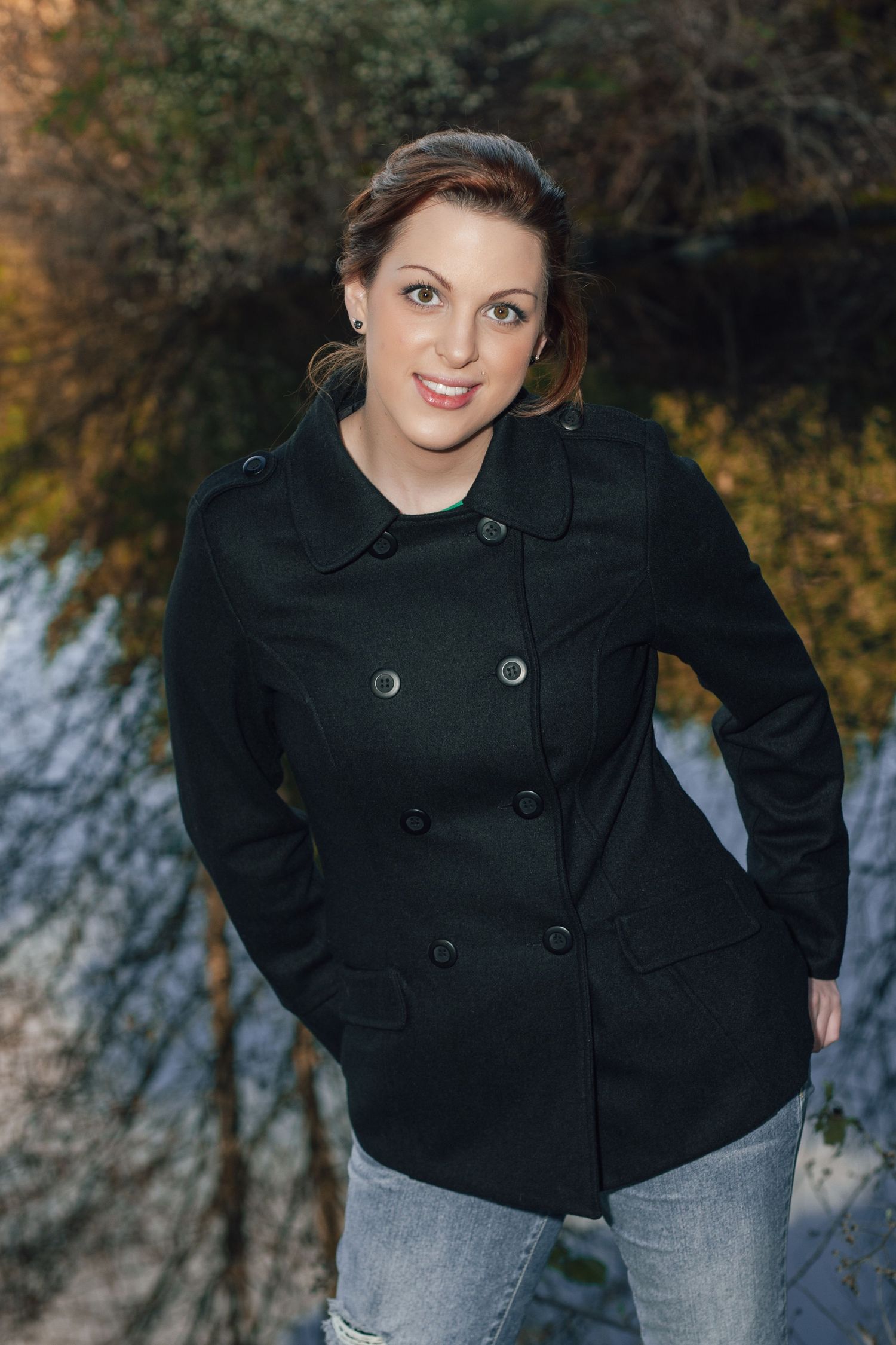 Portrait series in black peacoat with autumn foliage background.