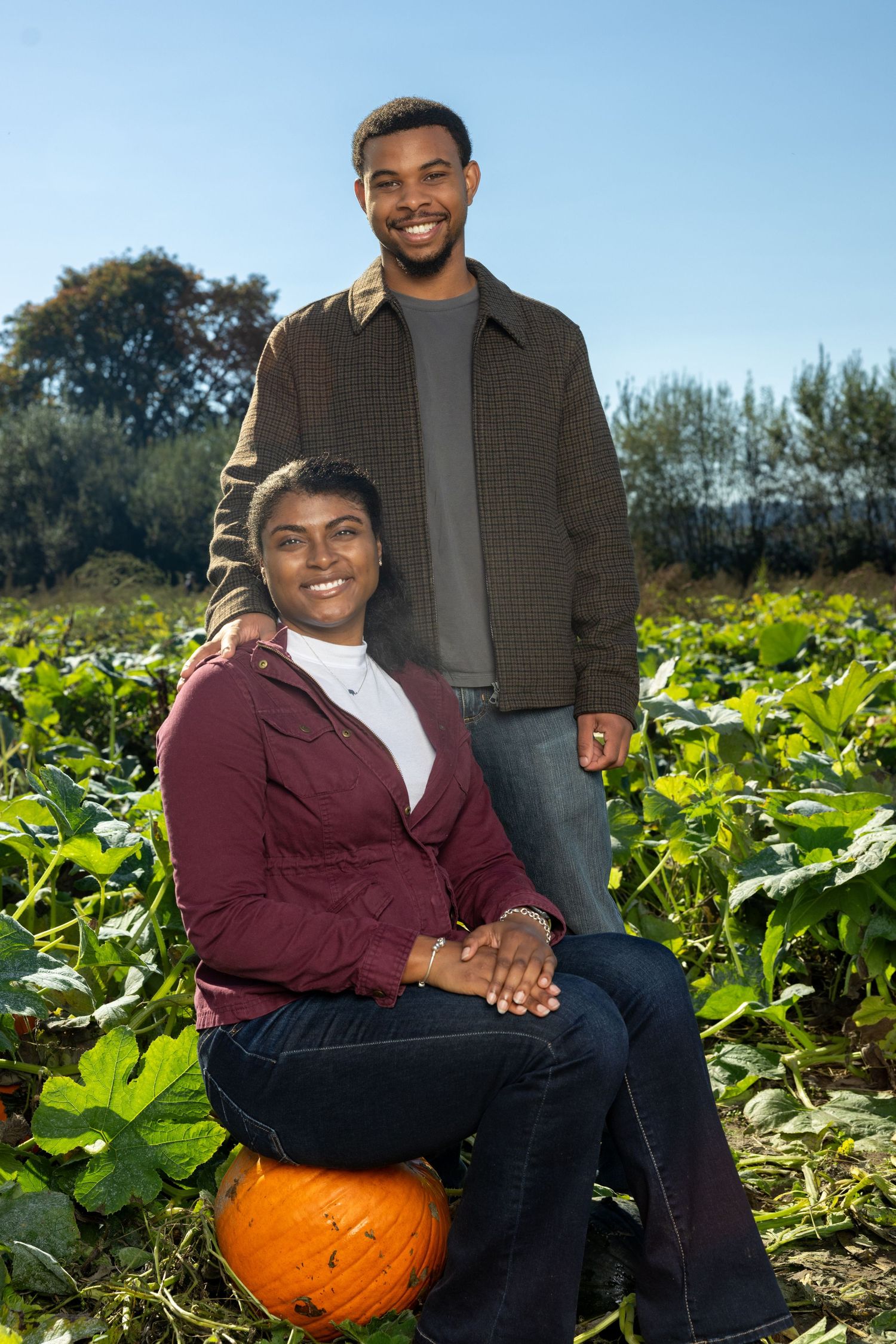 Fall pumpkin patch portrait session in bright sunlight.