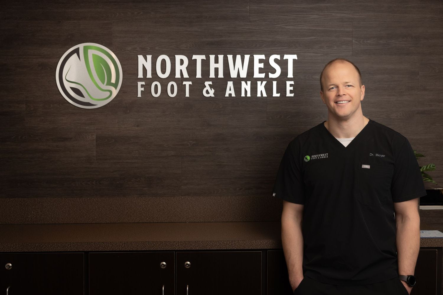 Professional medical office interior with Northwest Foot & Ankle signage and wood paneling.