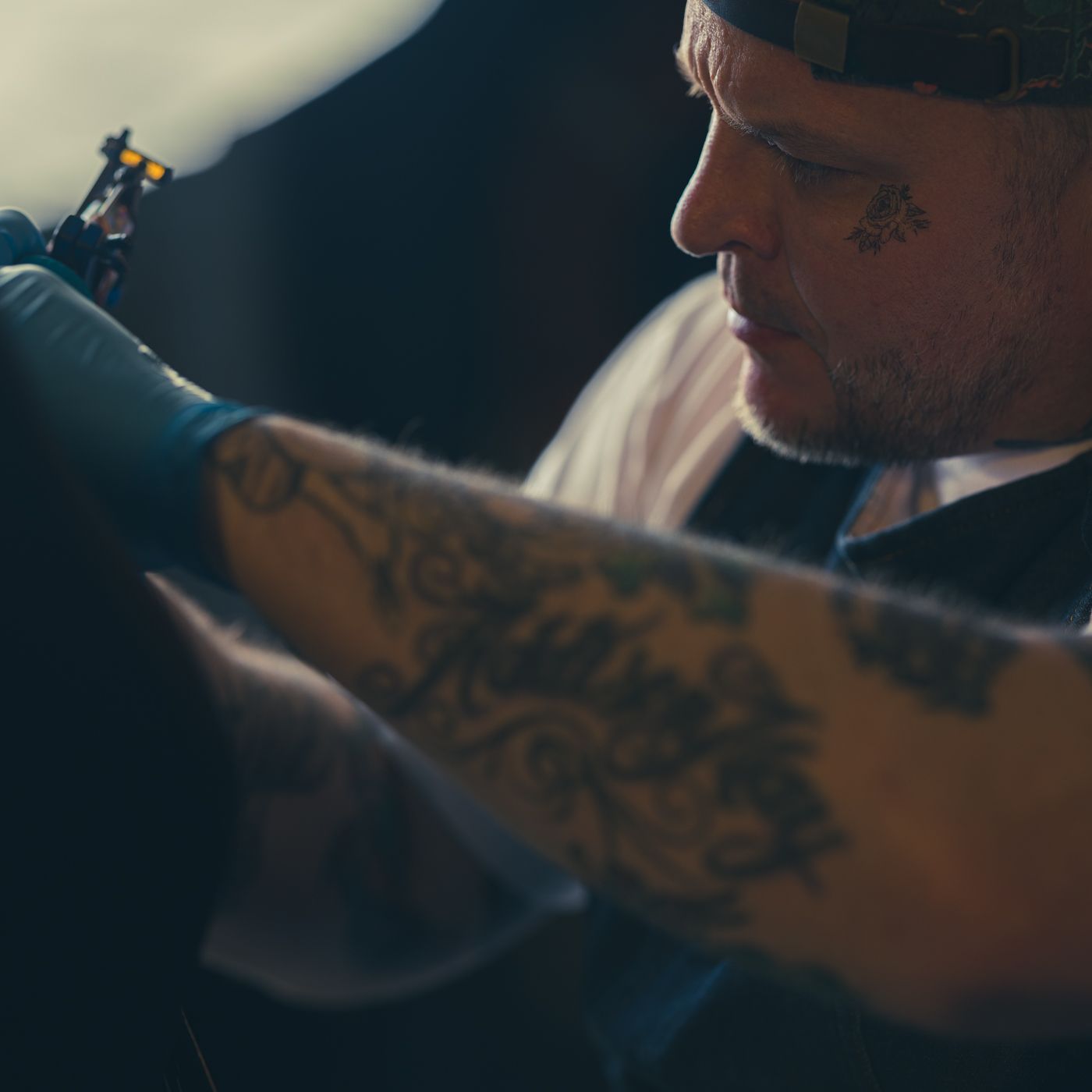 Close-up view of tattooed arm during inking process.