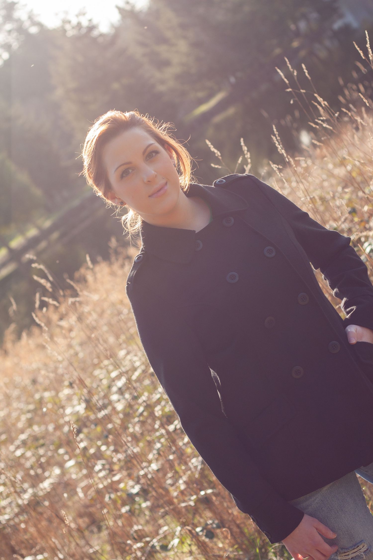 Artistic black coat fashion portraits in warm sunset lighting.