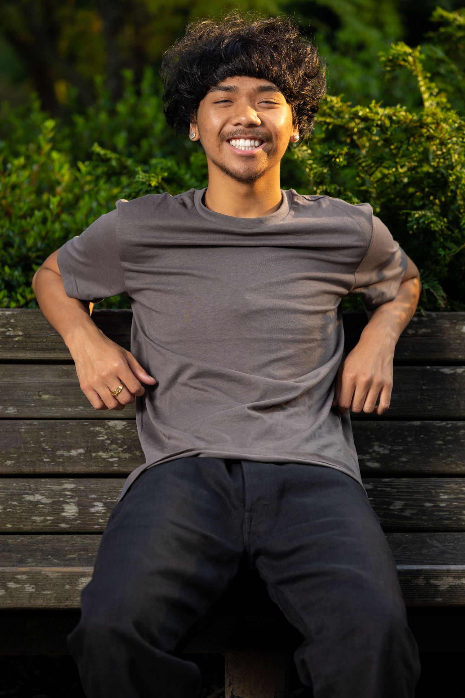 Casual portrait series on wooden bench with natural expressions.
