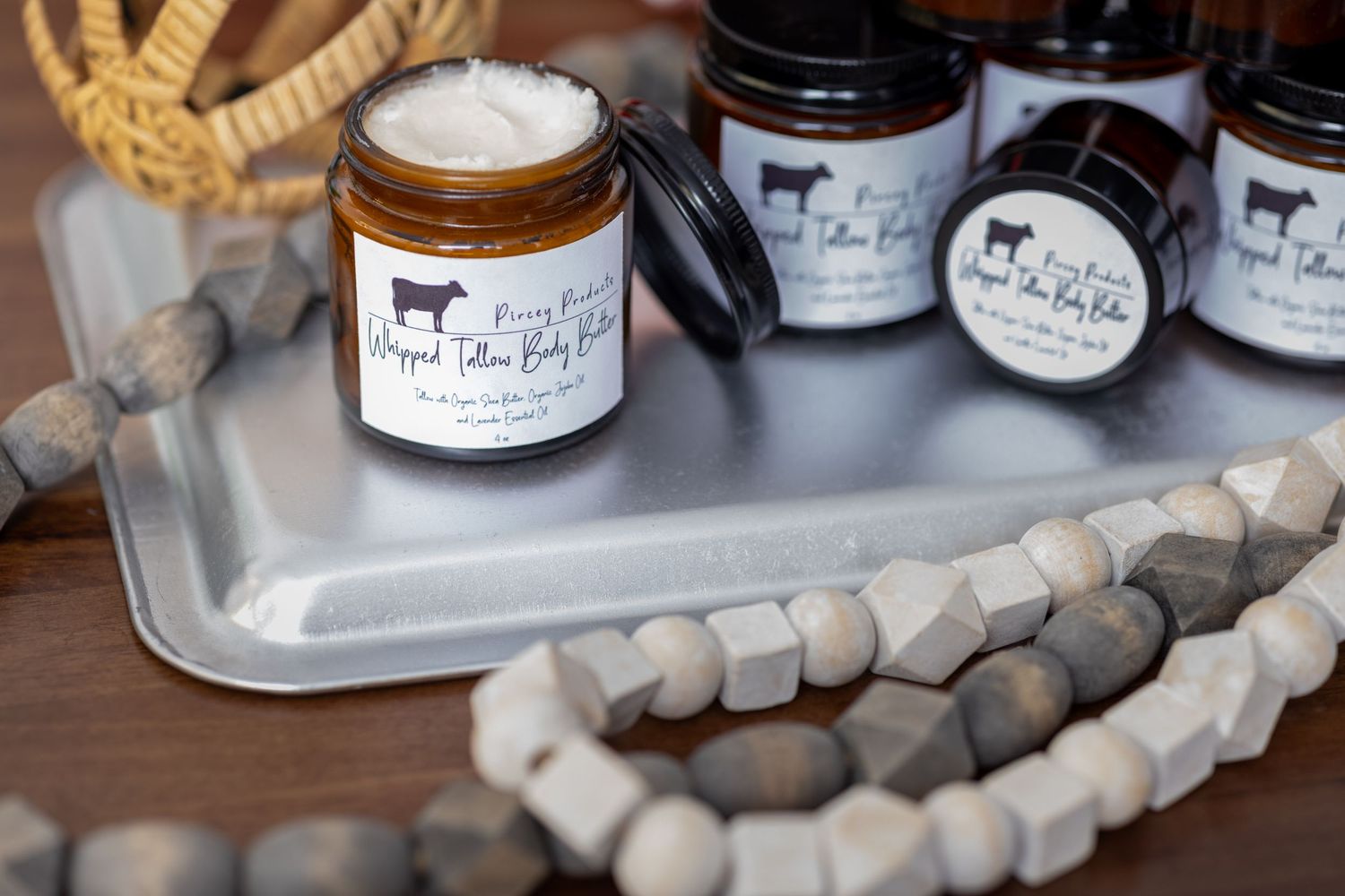 Display of artisanal food products with wooden bead garland decoration.